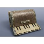 A 1950s novelty celluloid cigarette box modelled as an accordion, 18 cm x 15 cm high