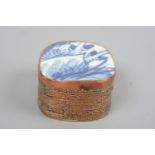 A small oriental copper box, the lid incorporating a shard of blue-and-white porcelain, 6 cm x 6