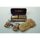 A set of late 19th / early 20th Century opera glasses in chamois purse, together with an early