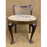 A 1930s cane-backed dressing table stool