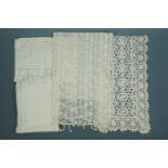 Sundry vintage textiles including a crocheted runner, an antimacassar, a whitework embroidered