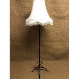 A wrought iron standard lamp