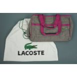 A vintage "as new" unused Lacoste tote bag, in a houndstooth checkered cotton, edged and piped in