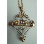 A Belle Epoque Art Nouveau openwork pendant brooch and neck chain, the pendant set with amethyst