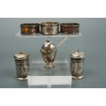 A pair of 1920s D-section silver napkin rings, one other silver napkin ring and a silver three-piece