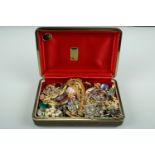 A 1950s Lionite musical jewellery box containing a quantity of period costume jewellery