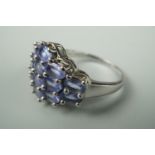 A contemporary dress ring, the face set with rows of pale purple coloured stones, stamped 935 and