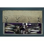 A boxed electroplate cake slice, dessert forks and spoons