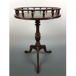 A reproduction Georgian gallery-topped tripod wine table