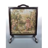 An embroidery and oak fire screen, 54 × 67 cm high