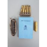 A Second World War Utility lighter, a 1944 soldier's New Testament, a jack knife and clip of