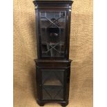An old reproduction astragal-glazed floor-standing corner cabinet