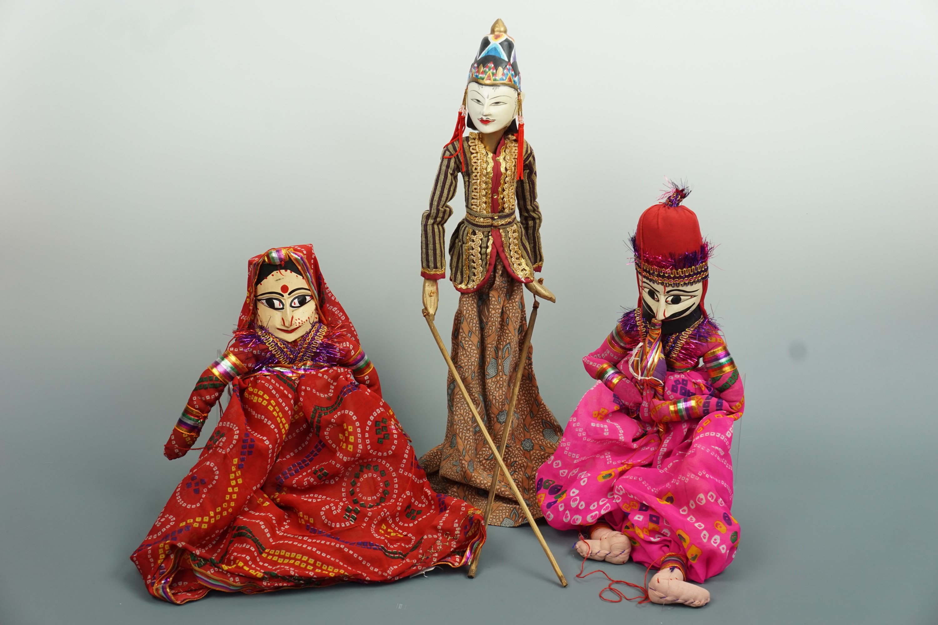 Three South Asian wooden dancing puppets, tallest 48 cm