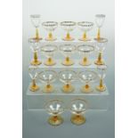 A suite of 1960s gilt-enriched wine and champagne glasses with amber stems