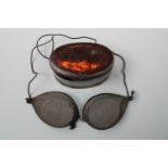 A set of Victorian wire gauze goggles in Japanned tinplate case