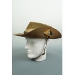 A Second World War British army bush / slouch hat, bearing a Royal artillery badge and backing,