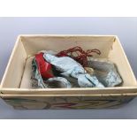 A vintage wedding garter and miniature wooden clogs in a period printed carton with gift note