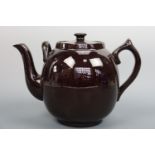 A vintage large treacle-glazed fireproof ceramic teapot