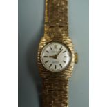 A 1970s lady's Chateau 9 ct gold dress watch, having an integral textured flexible bracelet strap,