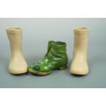 A pair of ceramic boots, 14 cm high, and one other
