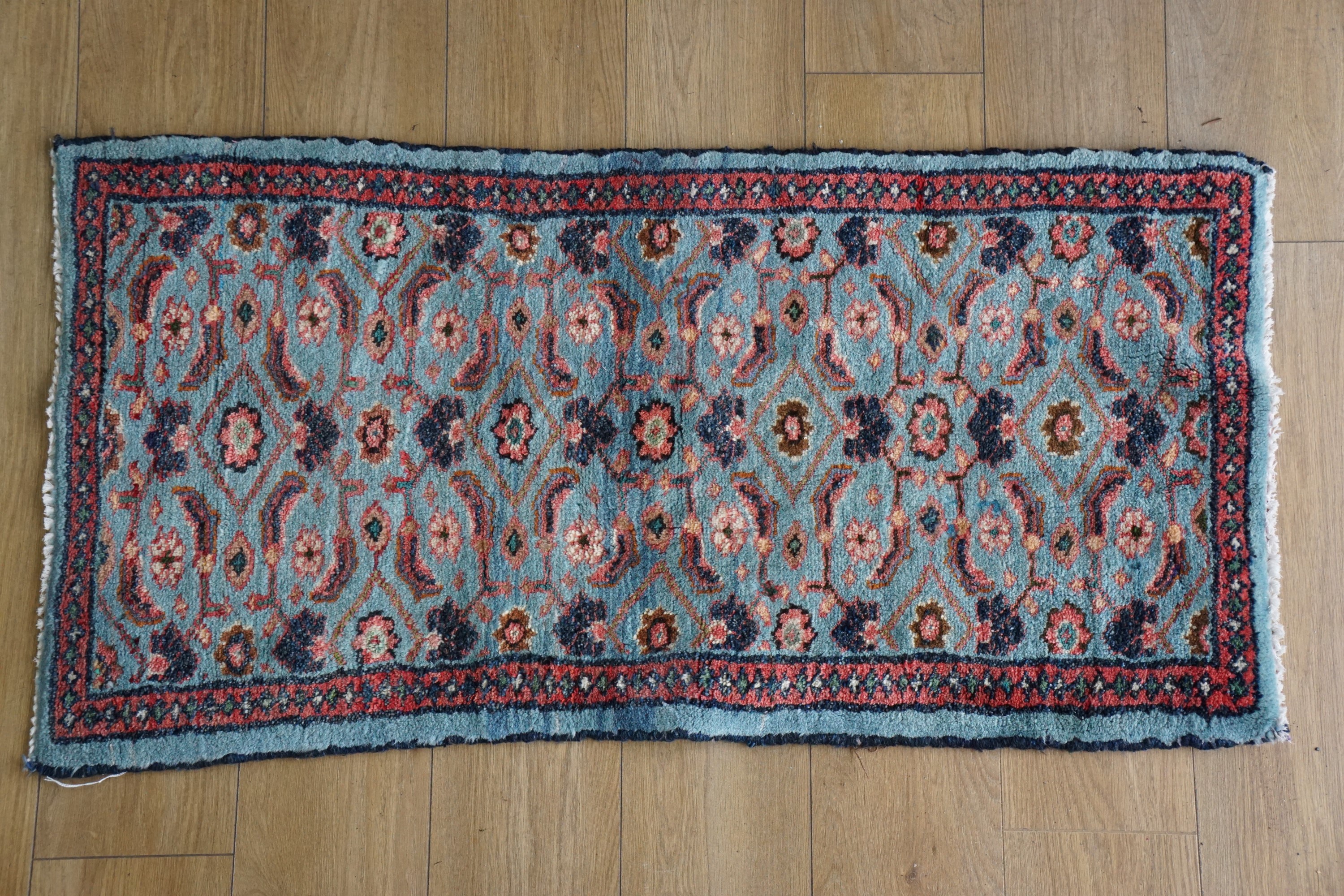 An oriental rug, 125 cm x 60 cm