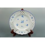 A Meissen hand-painted blue-and-white porcelain lattice-rimmed plate, decorated in a sparse