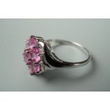 A contemporary pink sapphire and 9ct white gold dress ring, in a flower head cluster setting, size