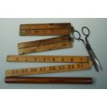 Three folding rulers, a dip pen straight edge / ruler and a set of Victorian steel scissors