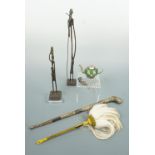 A pair of African cast figures, a fly whisk, carved horn staff, miniature oriental pot and pendant