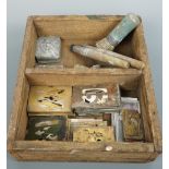 A quantity of military and similar number and letter stencils, in a wooden tray with brushes