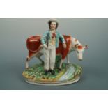 A Victorian Staffordshire earthenware figurine depicting a youth and cattle, 25 cm