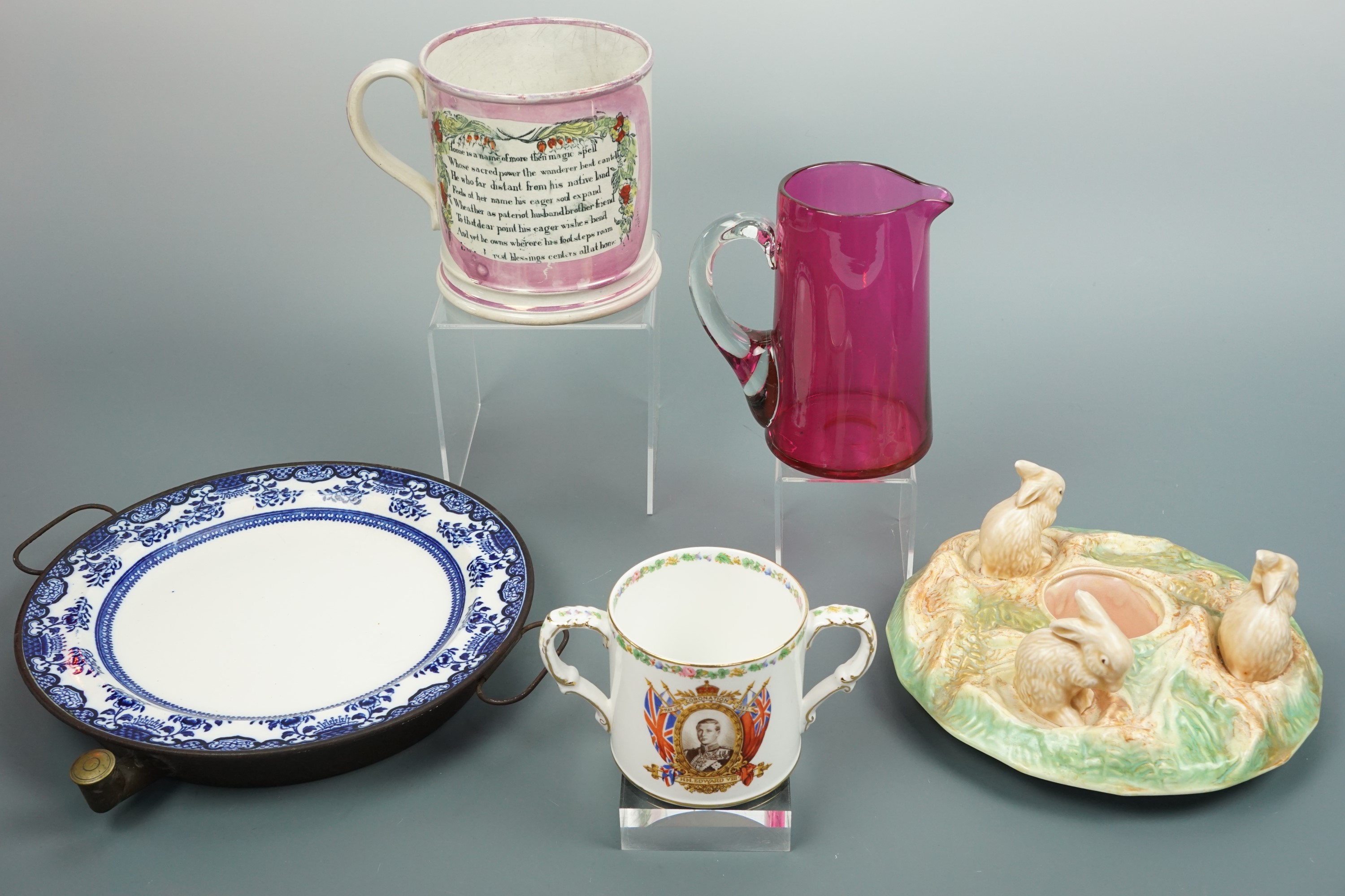 A Victorian warming plate, a Victorian "Sailor's Farewell" tankard, a cranberry glass jug and a