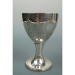 A George III white metal chalice, the bowl gilded internally and bearing the engraved arms of the