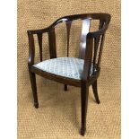 A 1930s mahogany horseshoe-back armchair