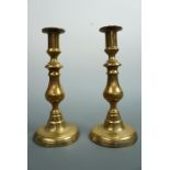 A pair of Victorian brass baluster push-eject candlesticks, 22.5 cm
