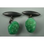 A pair of 1920s faux jade and silver cuff links, modelled as Japanese noh masks with silver