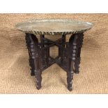 An antique Indo-Persian brass-topped folding table, 64 cm