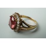 A contemporary lotus pink tourmaline and white topaz dress ring, in a flower head cluster setting,