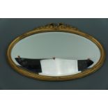 A gilt oval mirror, 59 × 41 cm