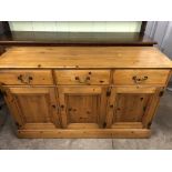 A traditional pine low dresser