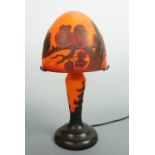 A reproduction Galle glass table lamp, of organic form, the shade decorated with owls perched on a
