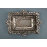 A late Victorian rectangular silver bowl, decorated in a relief pattern of floral swags, its everted