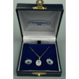 A blue and white stone flowerhead cluster pendant necklace and earring suite, set on 9 ct gold /