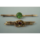 Two late 19th / early 20th Century yellow metal bar brooches, one set with a central green paste