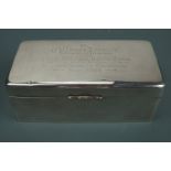 A considerable Victorian silver table cigarette box, its lid bearing an engraved presentation