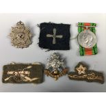 A Defense Medal, cap badges and cloth insignia
