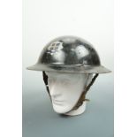 A 1941 Home Guard issue "raw-edged" steel helmet bearing black over-paint and fire service decal