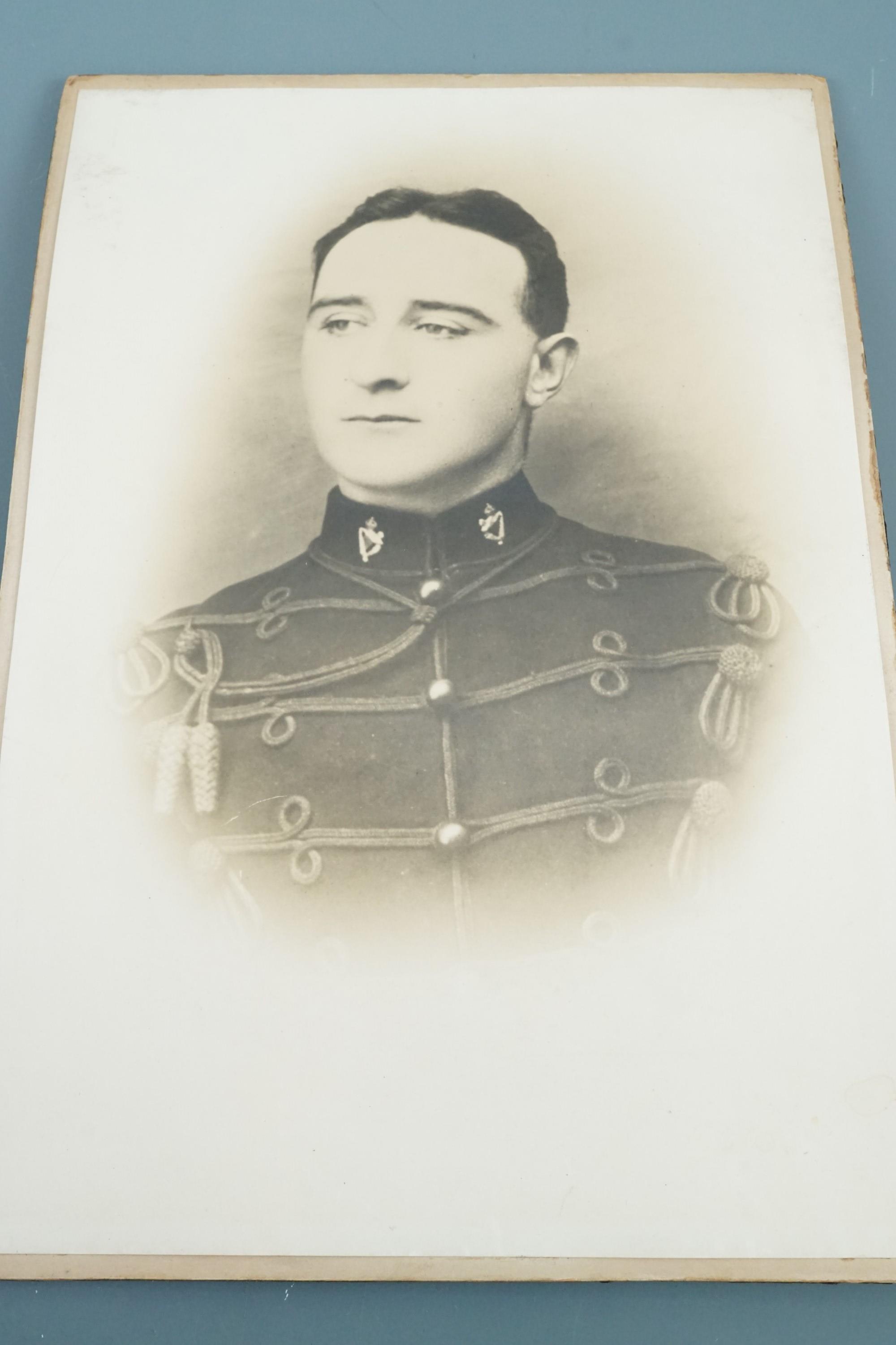 A framed pre Great War photograph of a British soldier wearing a Broderick cap, a framed 1918 army