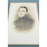 A framed pre Great War photograph of a British soldier wearing a Broderick cap, a framed 1918 army