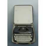 A vintage Olympia Splendid 66 typewriter and case